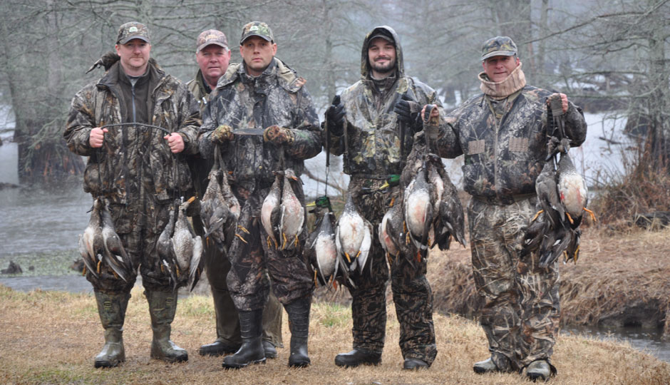 A group of hunters posing with their hunted ducks courtesy beaverdamducks.com