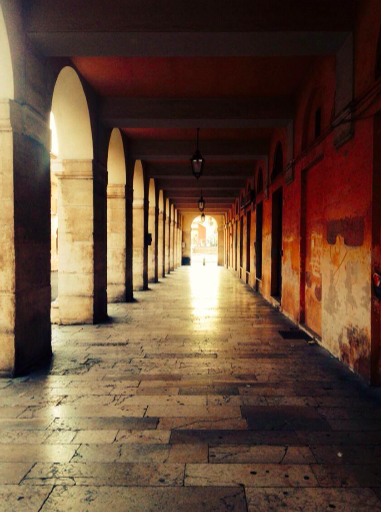 Colonnades and arcades of the Ercolani Porticos at sunset. Picture taken by the author
